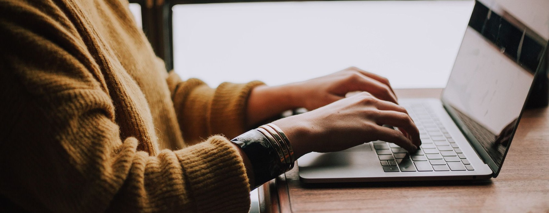 a woman typing on a computer