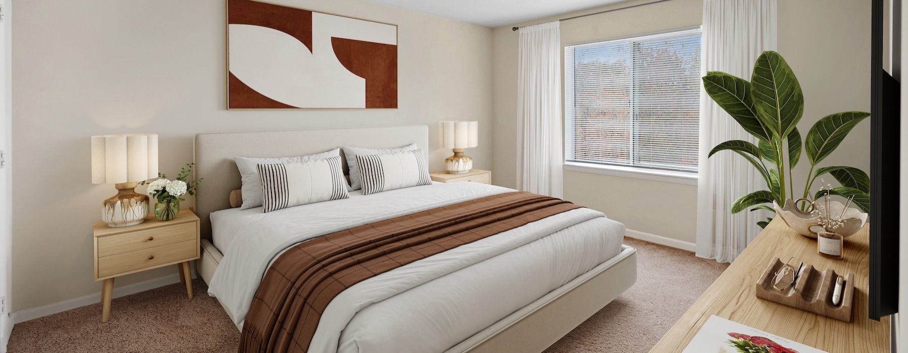Spacious bedroom with large window and plant