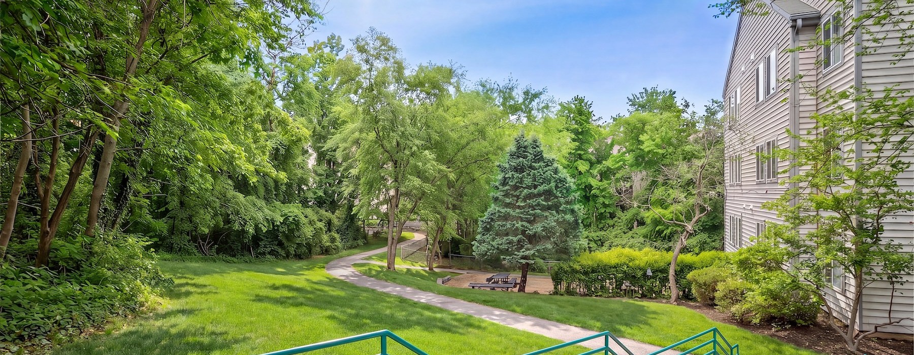 a grassy area with stairs and a walking path