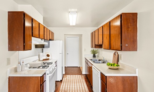 Kitchen with caramel cabinets and white appliances