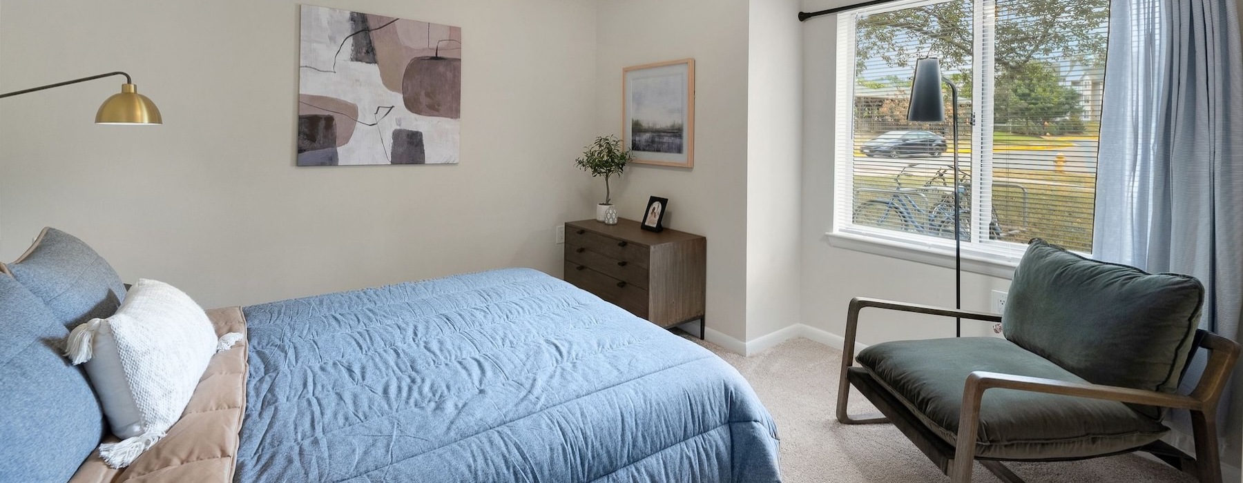 a bedroom with a bed and a chair