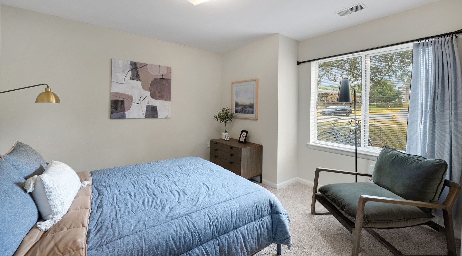 a bedroom with a bed and a chair